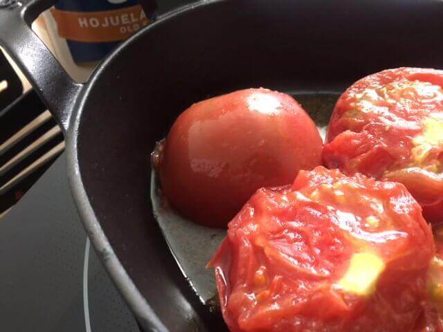 https://www.booniehicks.com/wp-content/uploads/2018/07/Tomatoes-cooking-in-enamel-cast-iron.jpg